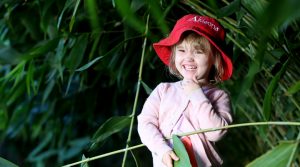 little girl laughing in the trees at a childcare centre